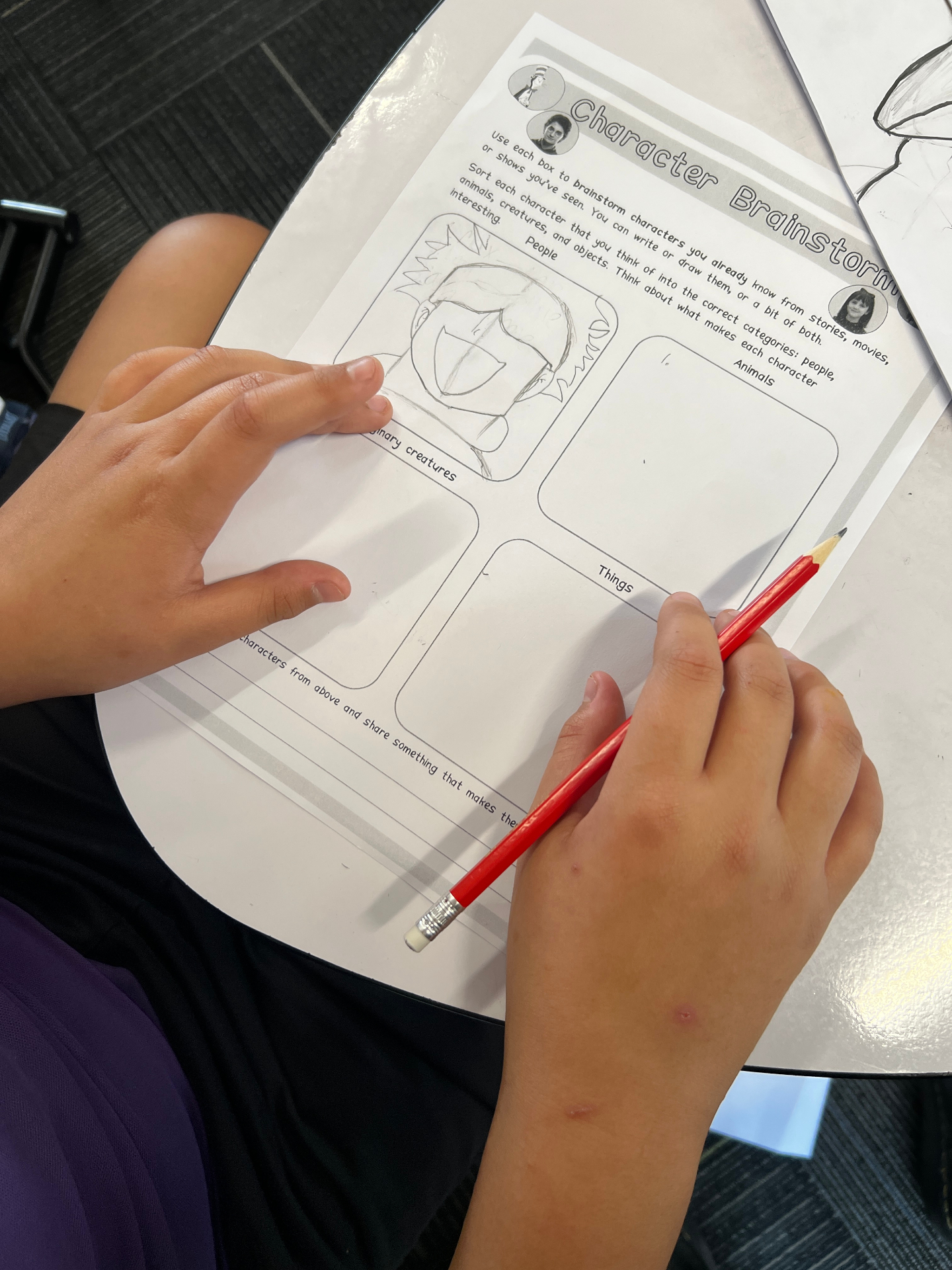 Student working on a Character Brainstorm worksheet
